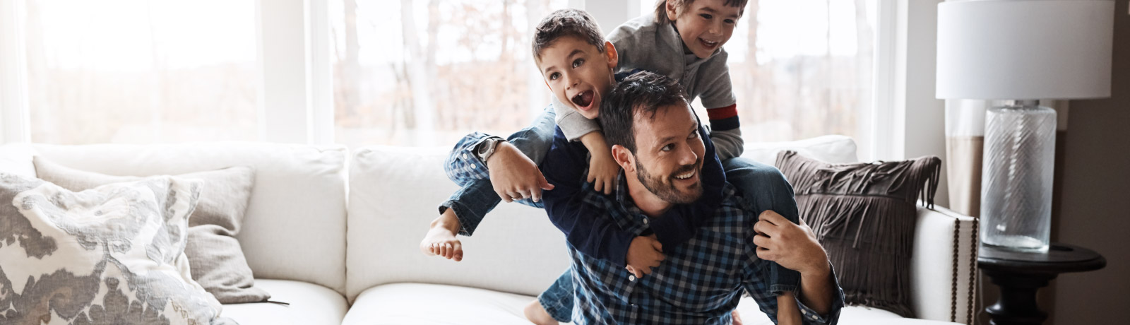 a father and his two sons playing in the living room