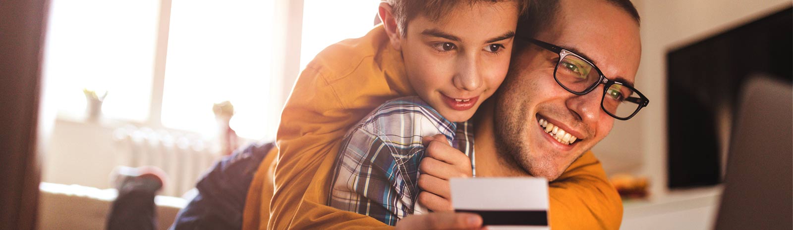 a father and son viewing a laptop