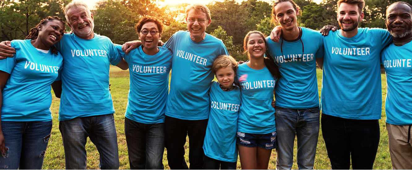 a group of people with blue volunteer shirts