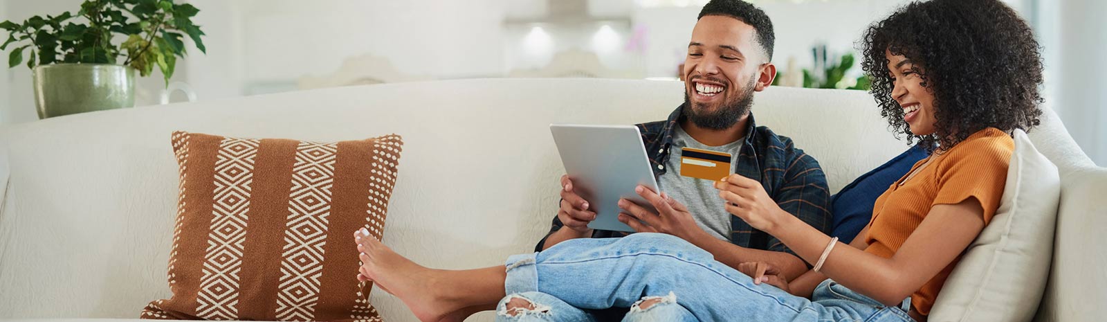 a couple sitting on a couch smiling